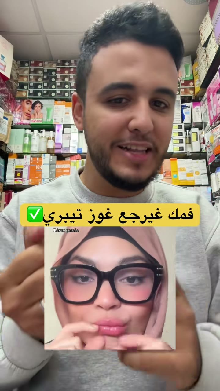Frame from a TikTok video: The salesperson shows Eva Senses Wild Raspberry lip scrub and picks some up with a cotton bud